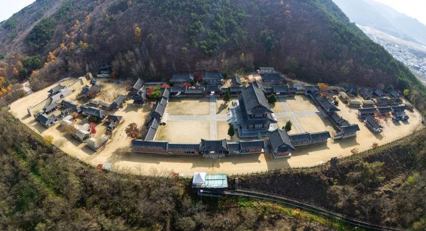 Traditional Korean drama open set buildings beneath the mountains at Mungyeong Saejae
